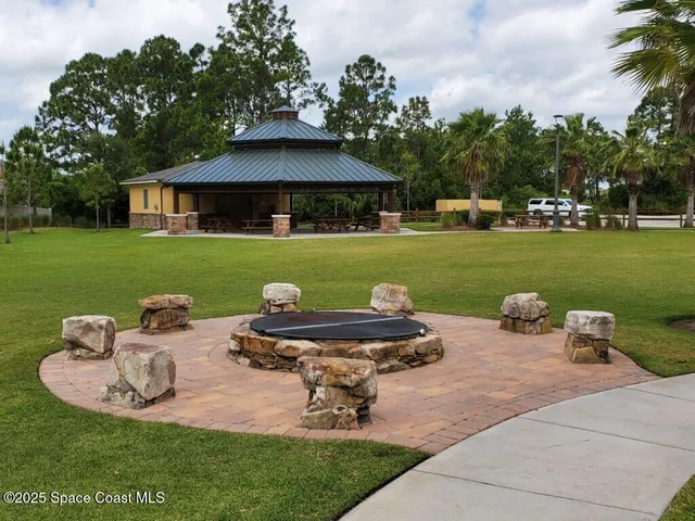a view of a swimming pool with a table and chairs