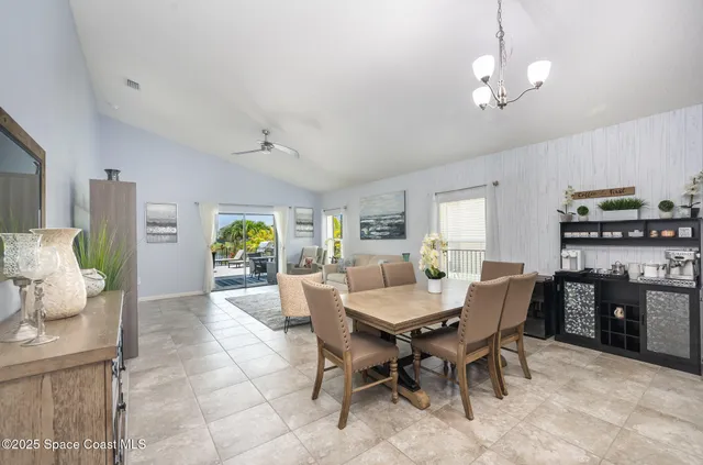 a view of a dining room with furniture and chandelier