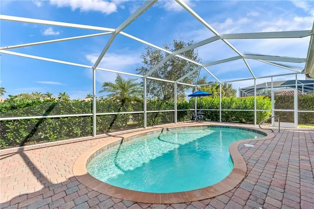 a view of a swimming pool with a yard