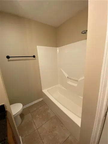 a bathroom with a shower and a toilet