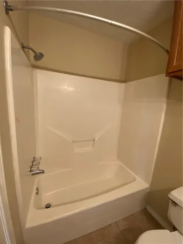 a bathroom with a shower and toilet