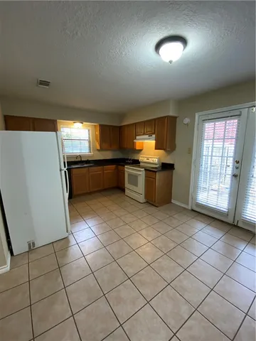 a kitchen with a sink and a refrigerator