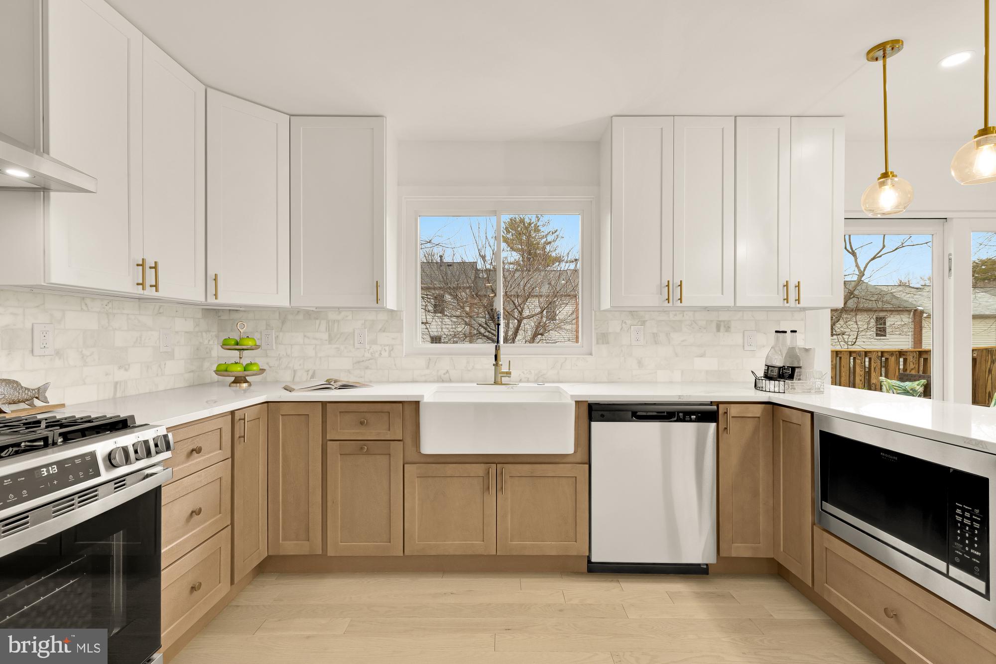 9532 Burdett Road Burke, VA 22015 - Photo 11 of 35 a kitchen with stainless steel appliances granite countertop a sink stove and cabinets