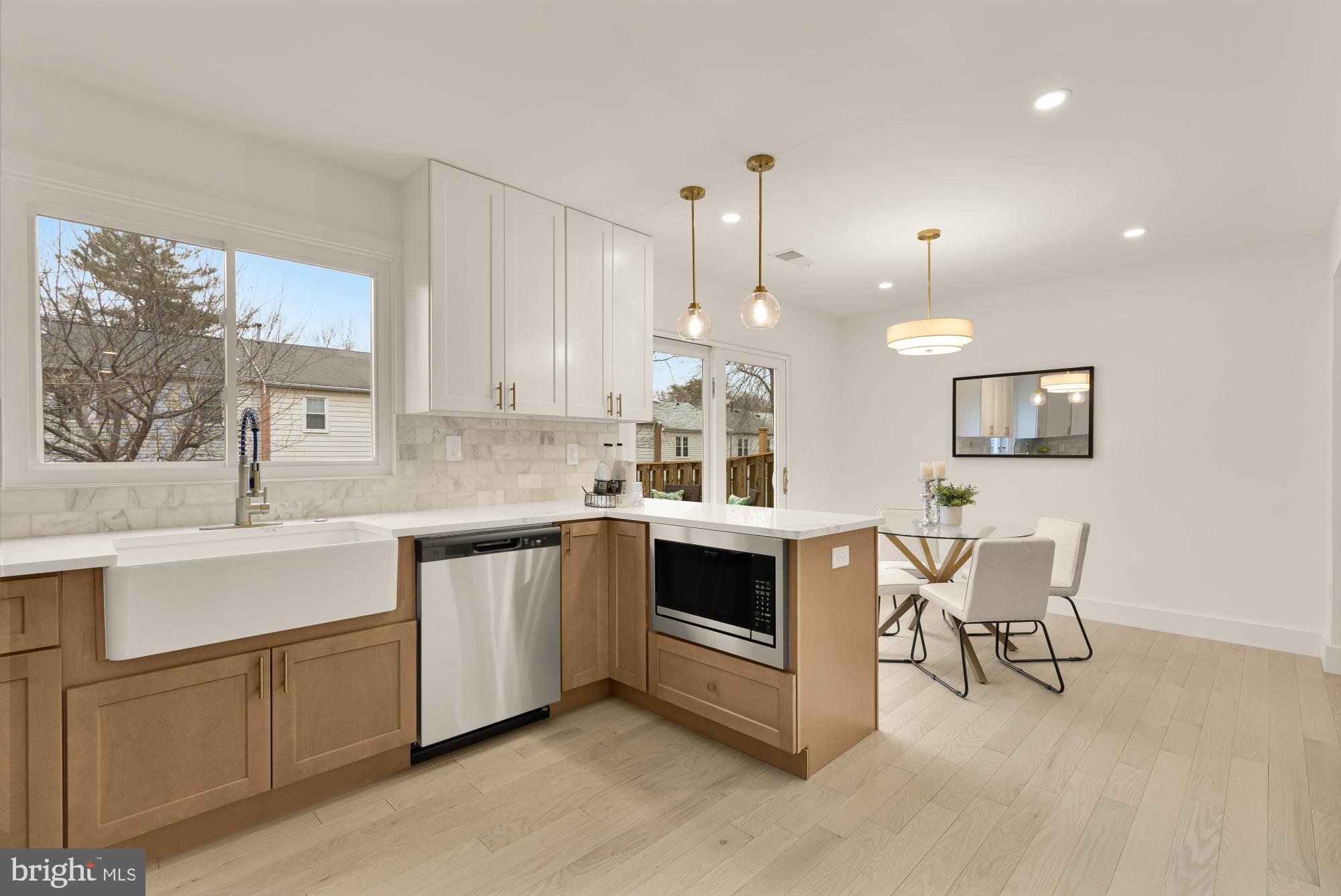 9532 Burdett Road Burke, VA 22015 - Photo 12 of 35 a kitchen with stainless steel appliances kitchen island granite countertop a stove a sink and a refrigerator