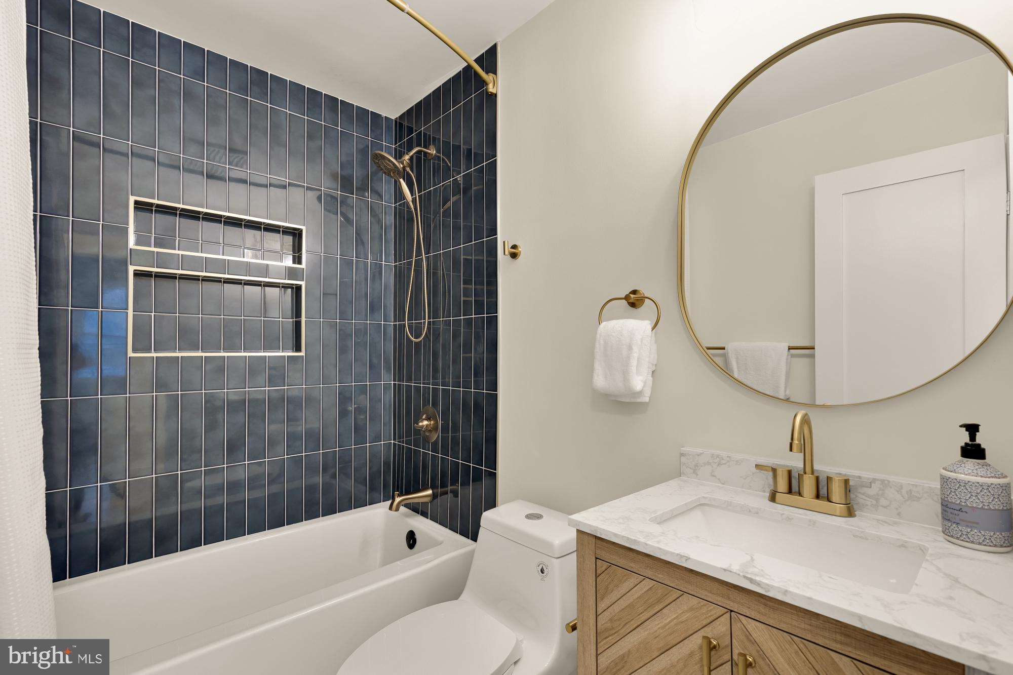 9532 Burdett Road Burke, VA 22015 - Photo 24 of 35 a bathroom with a sink toilet and shower