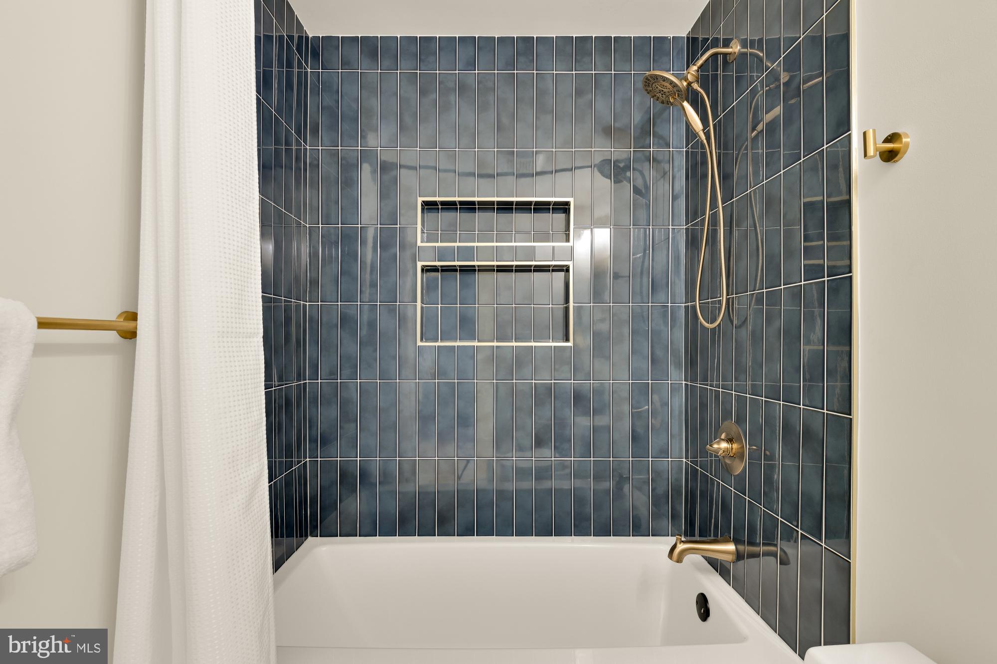 9532 Burdett Road Burke, VA 22015 - Photo 25 of 35 a bathroom with a bathtub and a shower