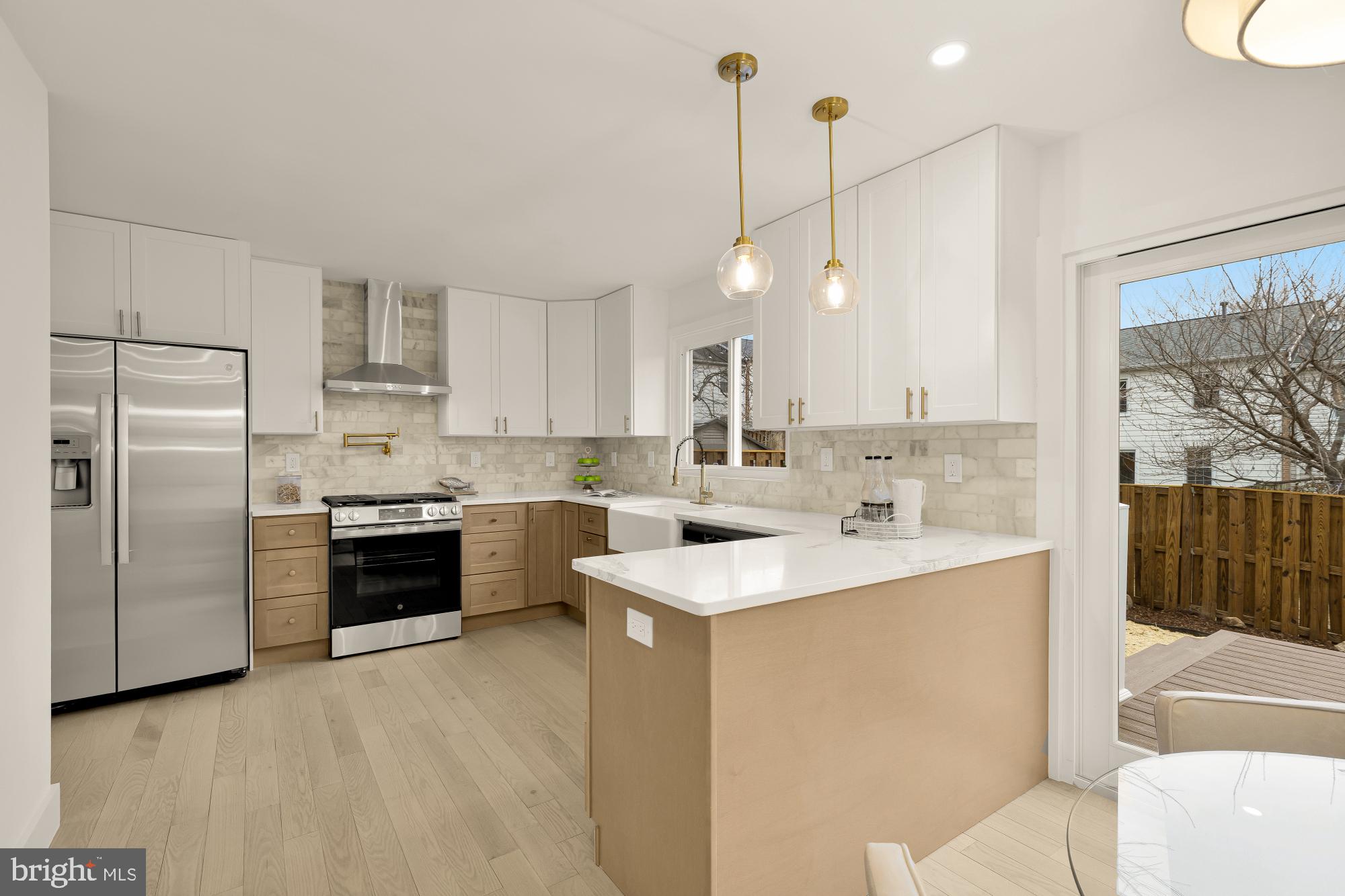 9532 Burdett Road Burke, VA 22015 - Photo 9 of 35 a kitchen with a sink a stove a refrigerator and a fireplace
