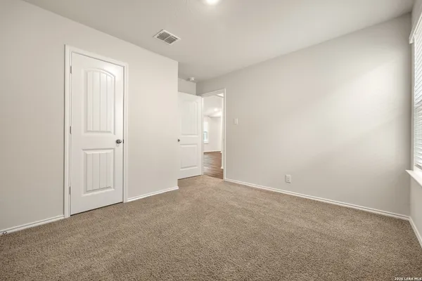 a view of an empty room and closet area