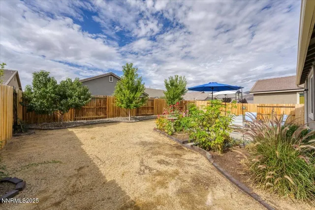 a view of a patio with a table and chairs under an umbrella