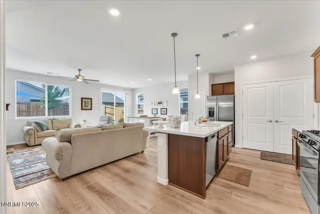a living room with furniture a fireplace and a floor to ceiling window
