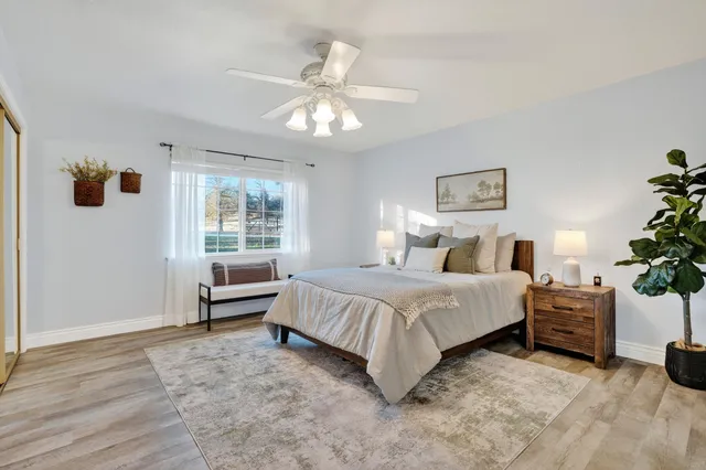 a spacious bedroom with a bed and a window