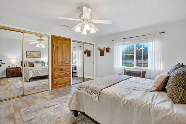 a bedroom with a large bed and a chandelier