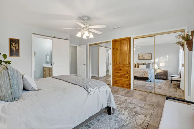 a spacious bedroom with a bed and a walk in closet