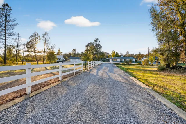 a view of a swimming pool with an outdoor seating and a yard