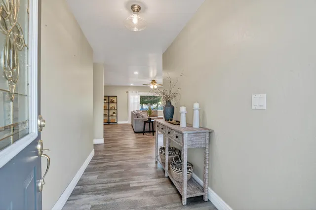 a view of living room with furniture and wooden floor
