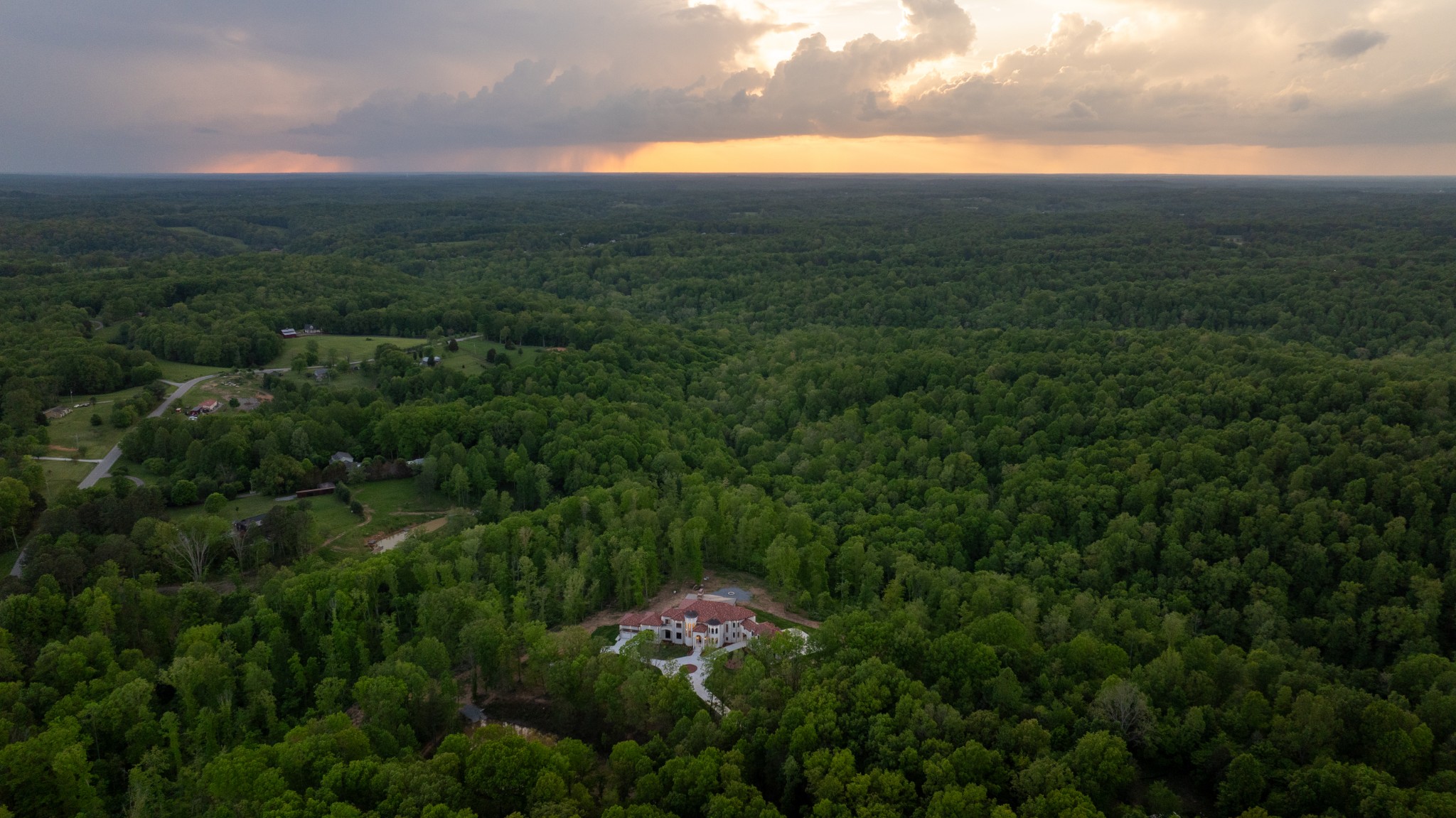 a view of a city with lush green forest