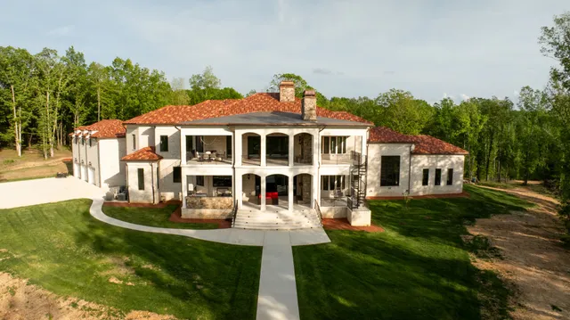 a front view of a house with a yard table and chairs