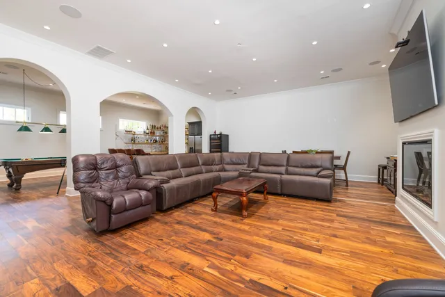 an empty room with wooden floor and a window