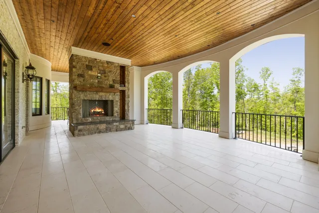 a kitchen with stainless steel appliances granite countertop white cabinets and a wooden floor