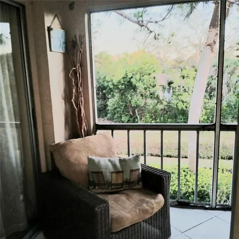 a bed sitting in a balcony next to a window