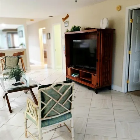 a living room with a flat screen tv and outdoor seating