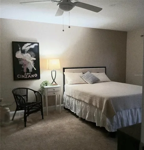 a bedroom with a bed and chair