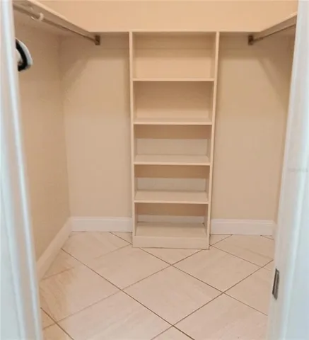 a view of walk in closet with empty racks