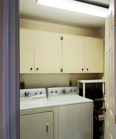 a view of storage and utility room with washer and dryer