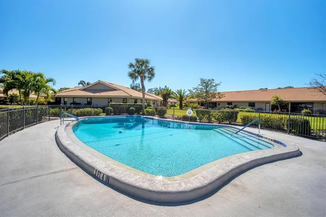 a view of a swimming pool with a yard and mountain