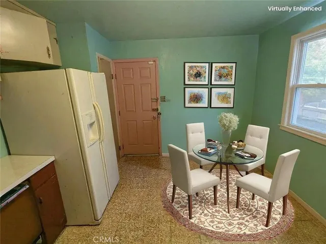 a view of a dining room with furniture and a window