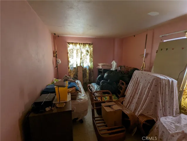 a bedroom with a bed and a dresser in it