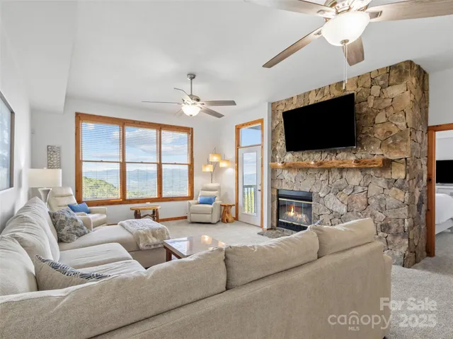 a living room with fireplace furniture and a flat screen tv