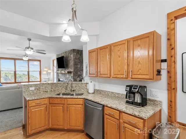 a kitchen with stainless steel appliances granite countertop a sink stove and cabinets