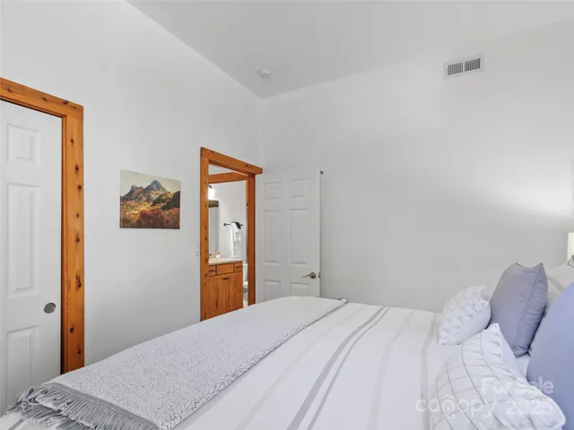 a bedroom with a bed and wall painting