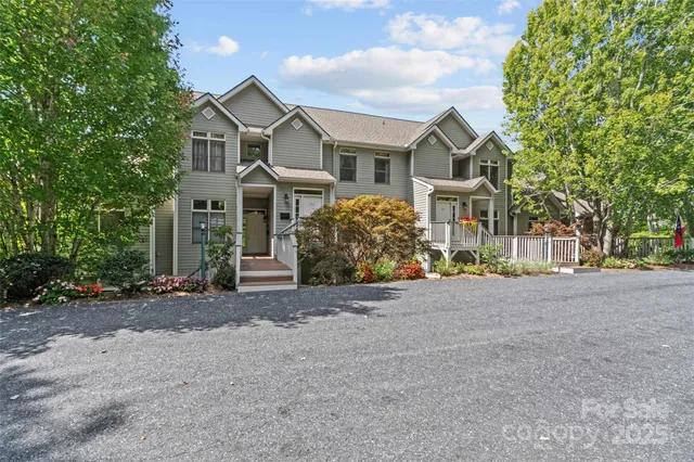 a front view of a house with a yard and a garage