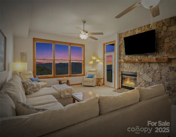 a living room with furniture a flat screen tv and a fireplace