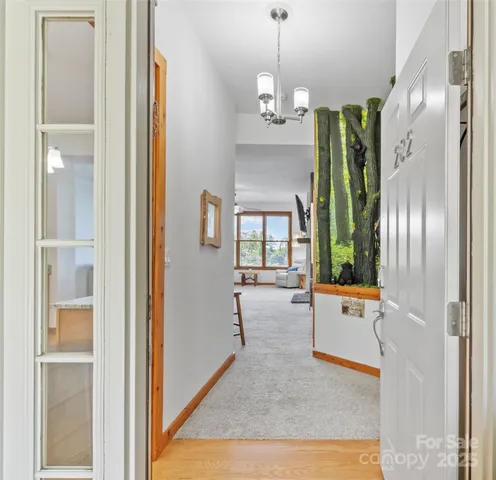 a view of an entryway with wooden floor and a livingroom
