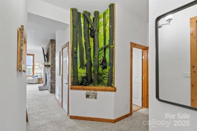 a view of a hallway with a door and stairs