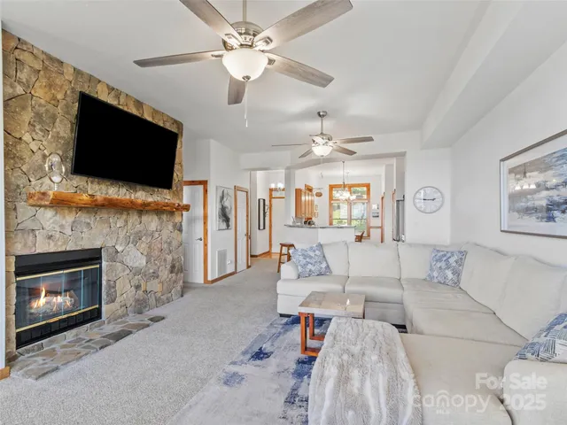 a living room with furniture a flat screen tv and a fireplace