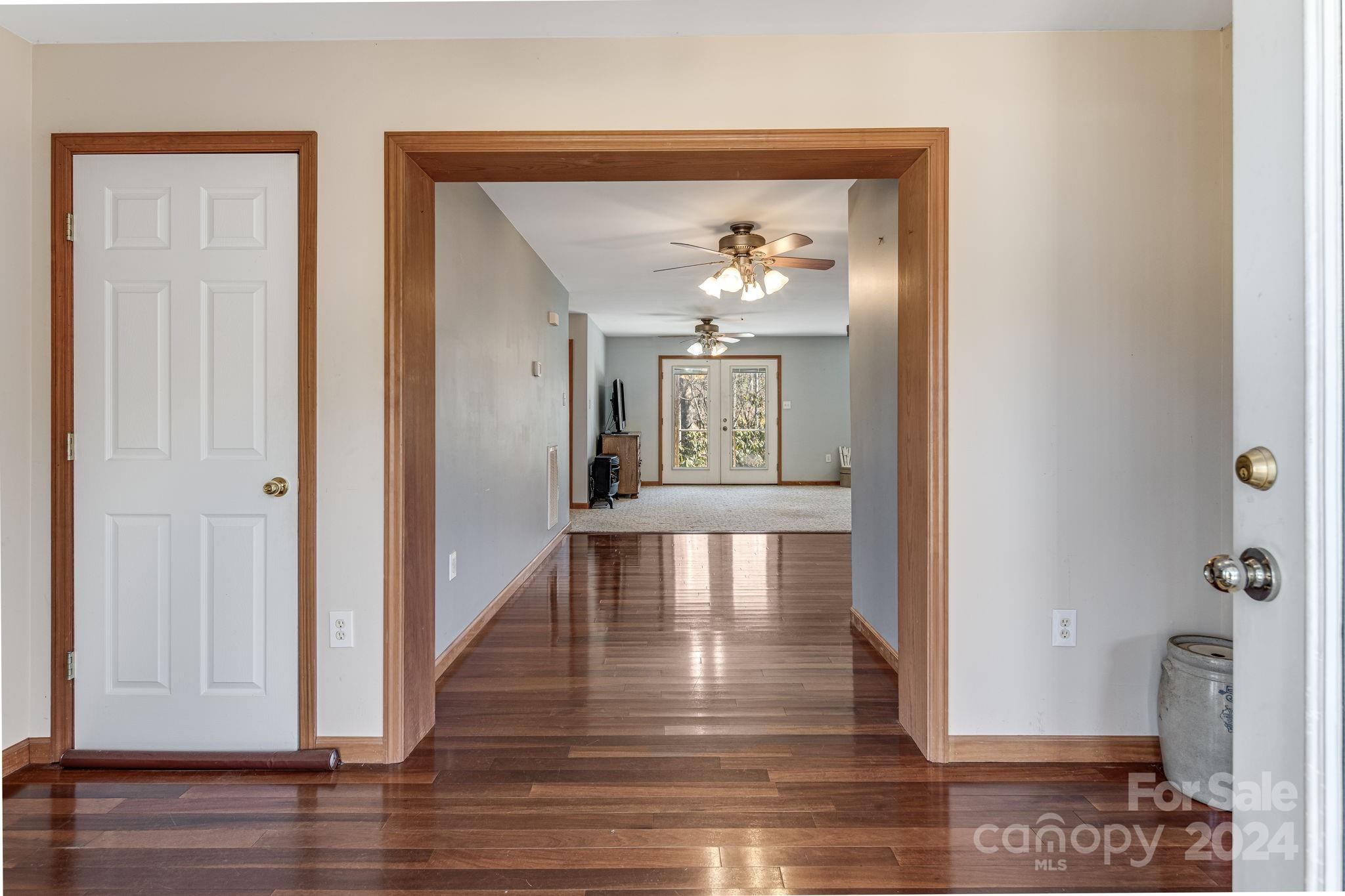 10 Bailey Ridge Road Black Mountain, NC 28711 - Photo 13 of 44 a view of a hallway with wooden floor and a chandelier