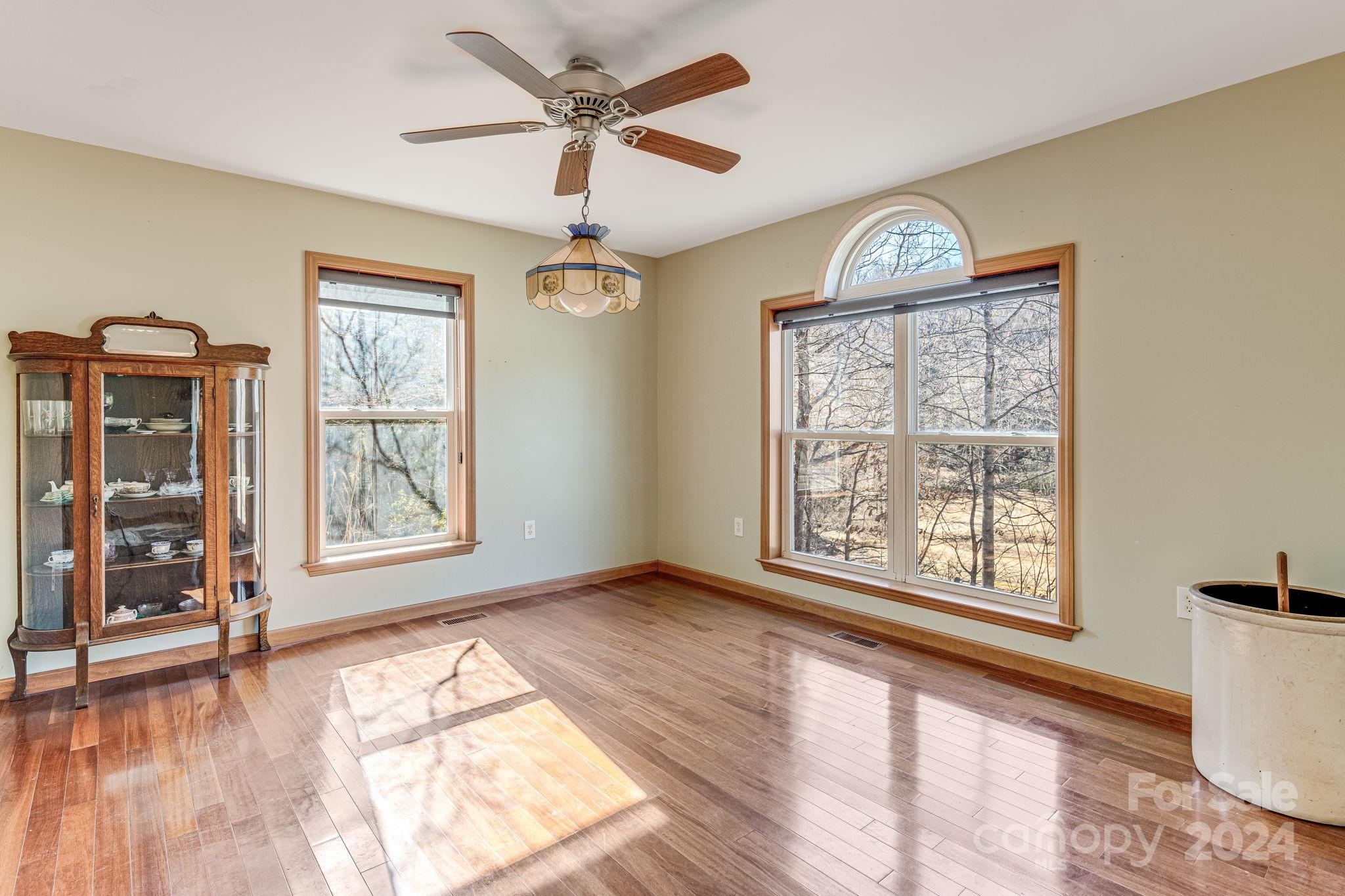10 Bailey Ridge Road Black Mountain, NC 28711 - Photo 23 of 44 a view of an empty room with a window and wooden floor