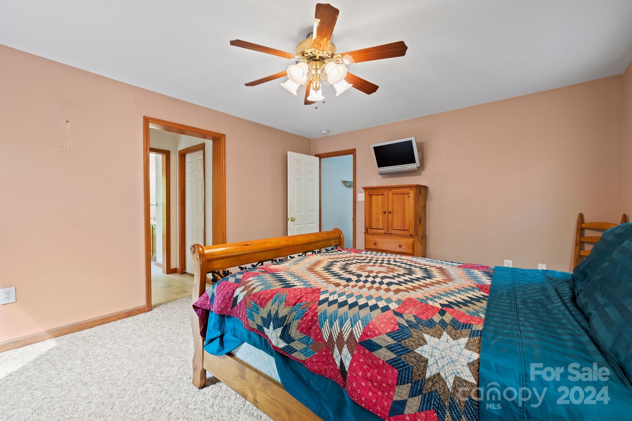 10 Bailey Ridge Road Black Mountain, NC 28711 - Photo 26 of 44 a bedroom with a bed and a chandelier