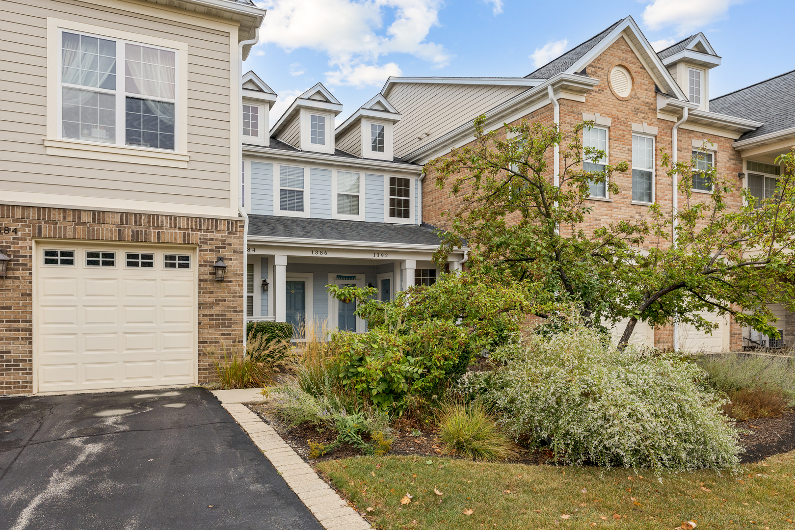 a front view of a house with a yard garage and outdoor seating