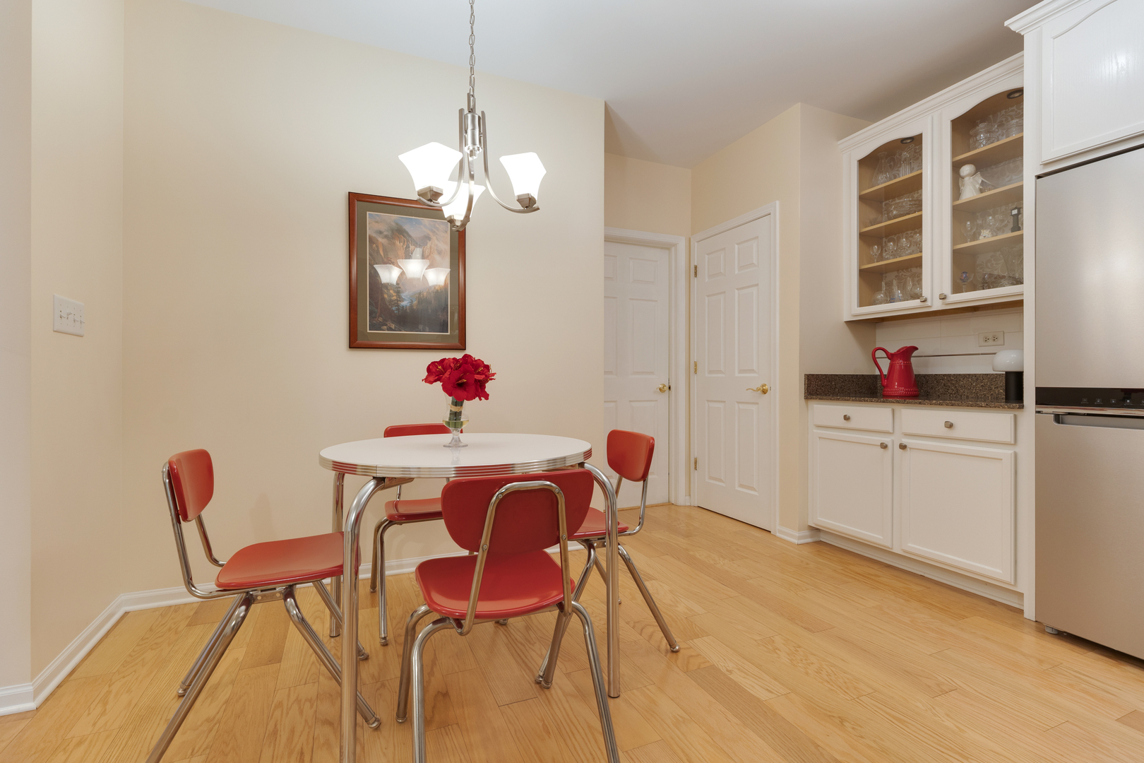 1386 Scarboro Road, Unit 1102 Schaumburg, IL 60193 - Photo 6 of 26 a view of a dining room with furniture and chandelier