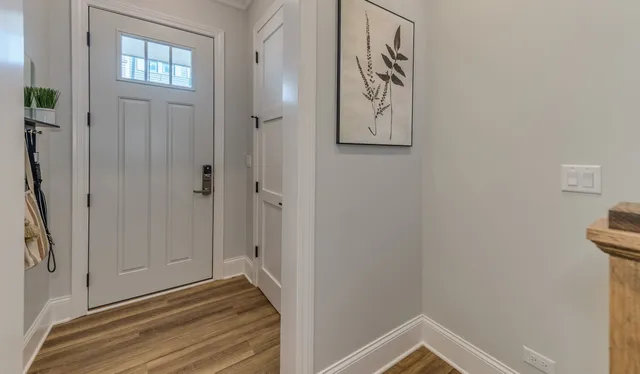 a view of an entryway with wooden floor