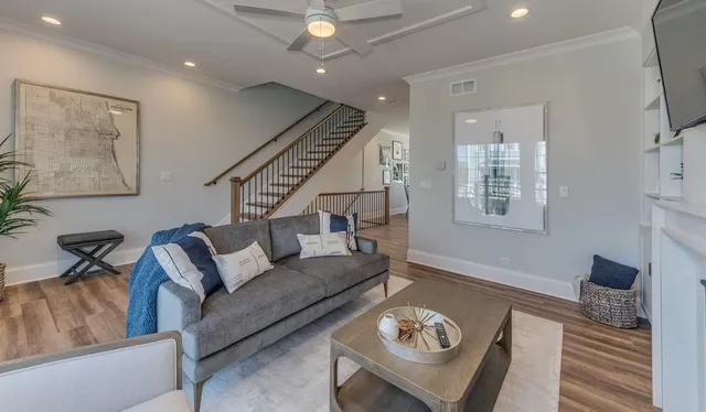 a living room with furniture and a wooden floor