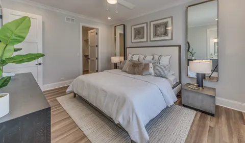 a bedroom with a bed and a lamp