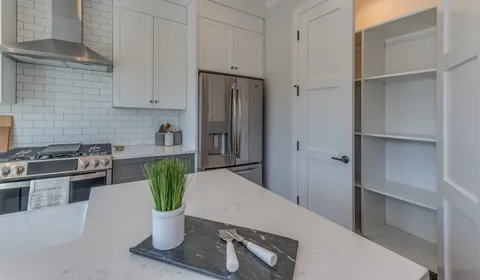 a kitchen with a refrigerator and a stove
