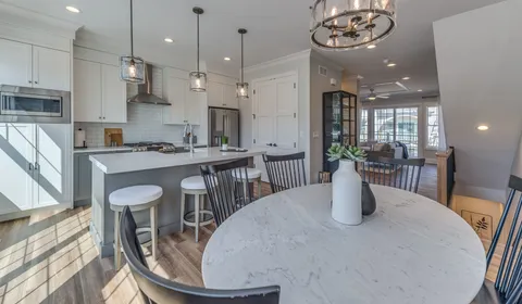a kitchen with a table chairs and a dining table