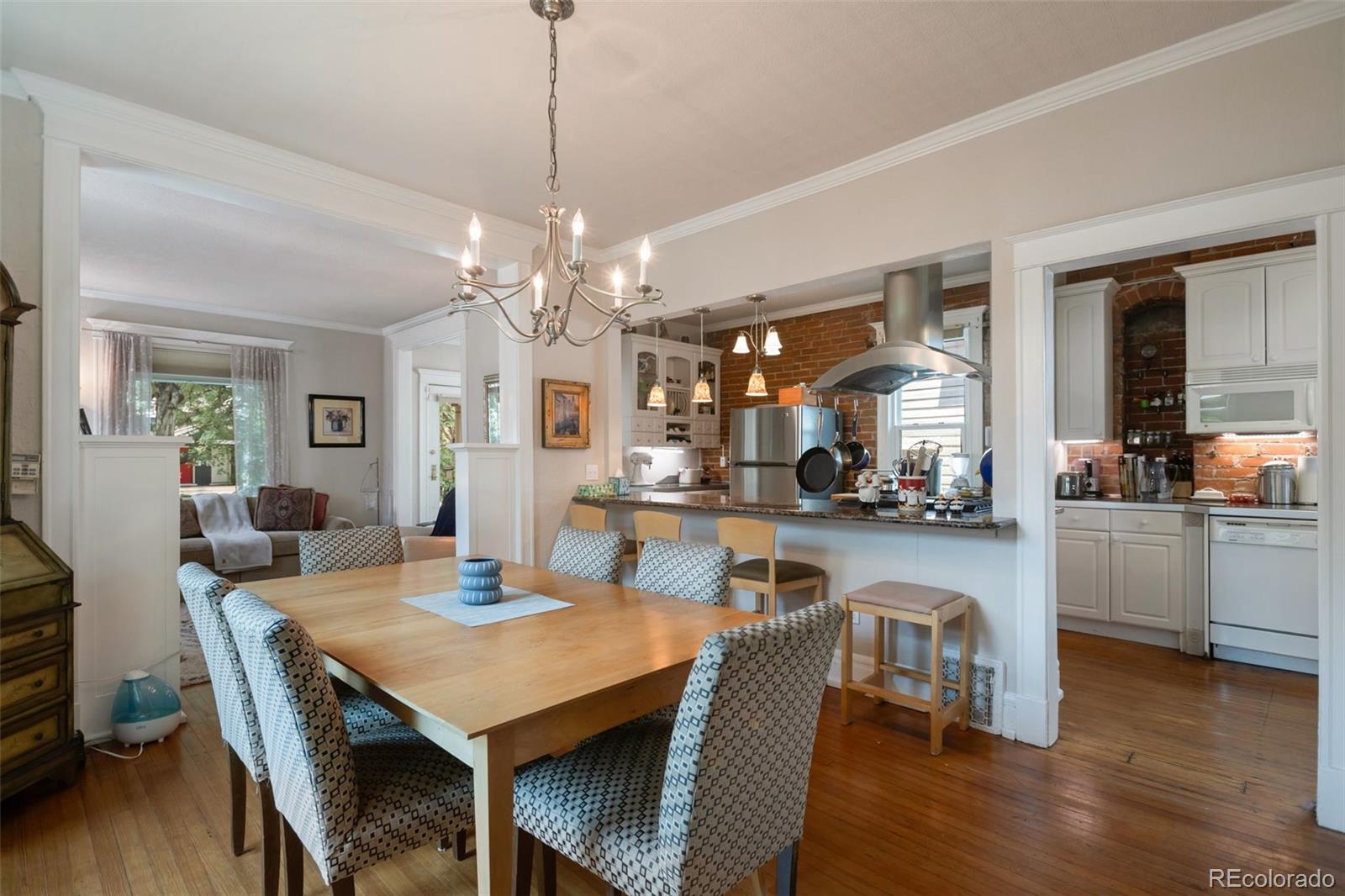 3732 Alcott Street Denver, CO 80211 - Photo 11 of 19 a view of a dining room and livingroom with furniture wooden floor a chandelier
